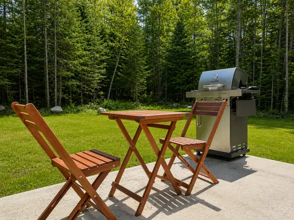 Outdoor bistro table and grill set up on the patio