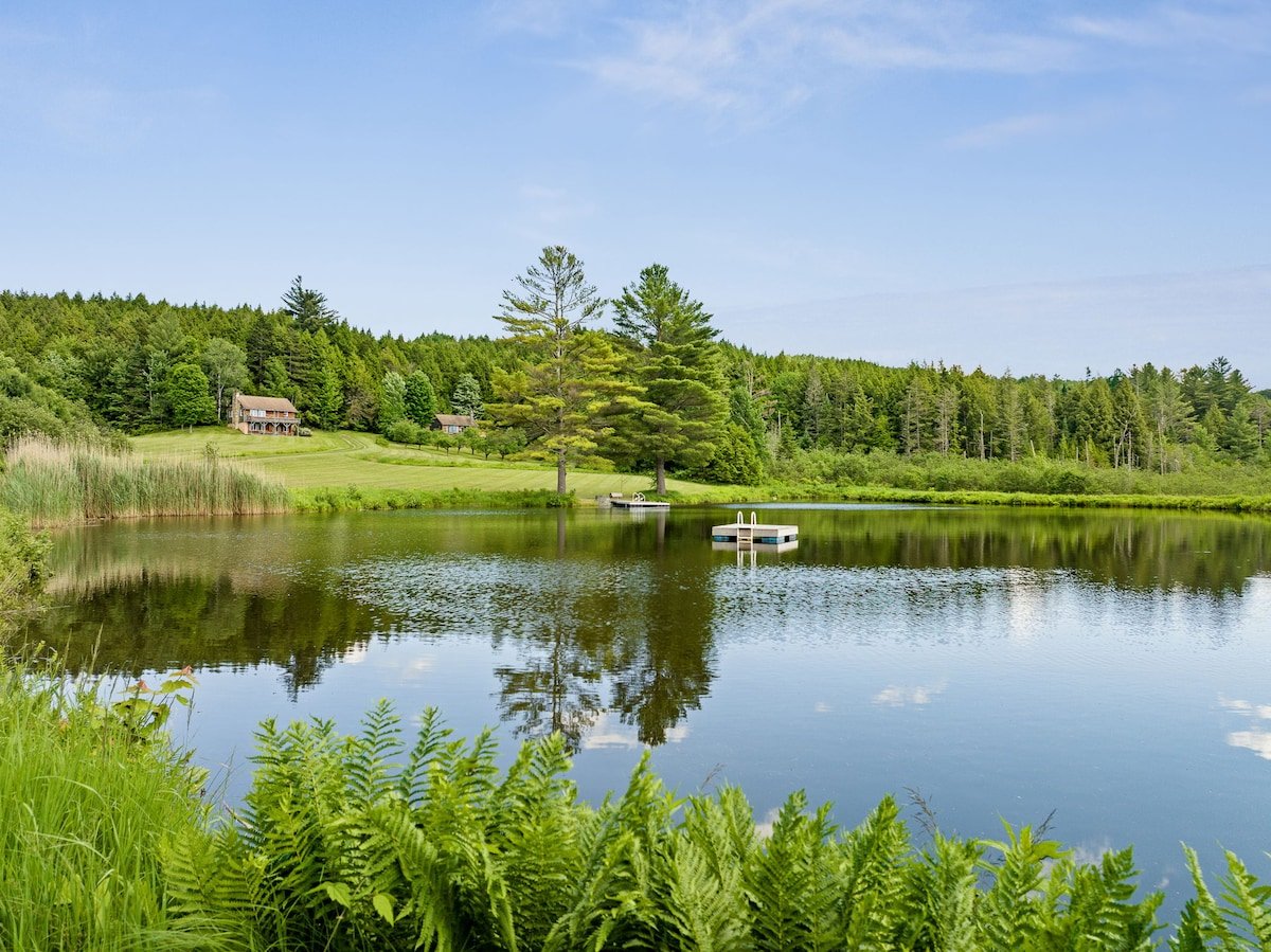 Private swimming pond with dock on a summer afternoon