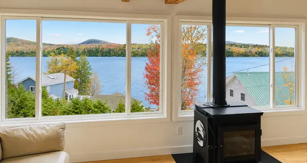 Wood stove and corner windows looking across to Lake Willoughby