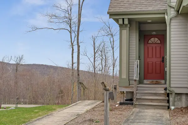 Approach to the condo with red door framed by Jay Peak