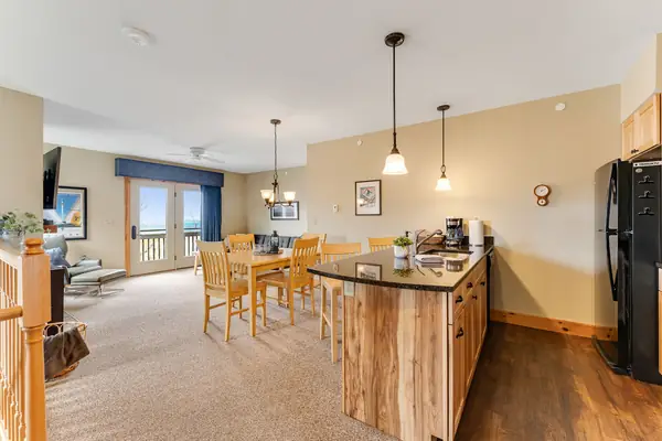 Open-concept kitchen and dining with mountain views from the balcony