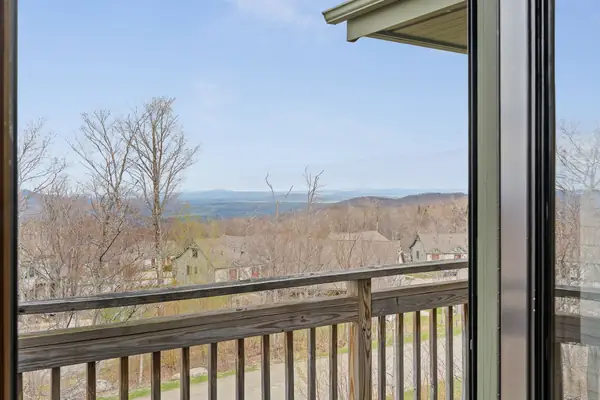 Private walk-out balcony with sweeping views of the Green Mountains