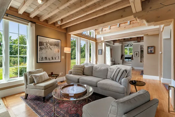 Living room overview with armchairs and beamed ceiling