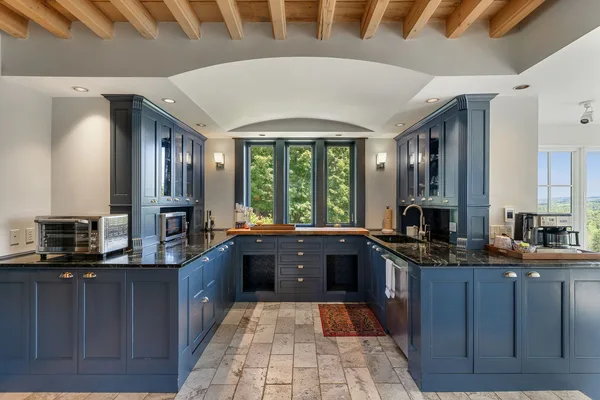 Kitchen with professional stove and blue cabinetry