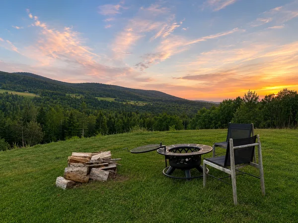 Sunset over meadow with fire pit