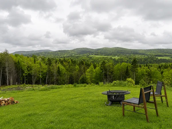 Meadow with adirondack chairs and view