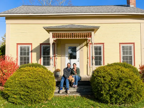 Front of the cottage with red trim and bright entry