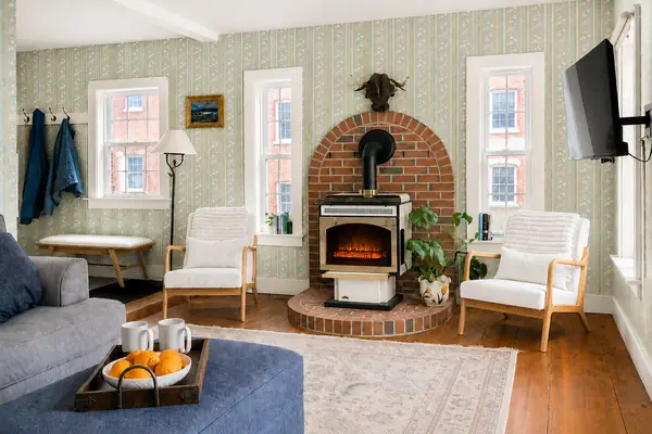 Living room with brick fireplace and woodstove
