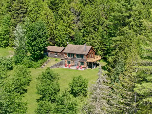 Aerial view of house and open field
