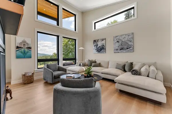 Vaulted living room with tall windows over the Northeast Kingdom