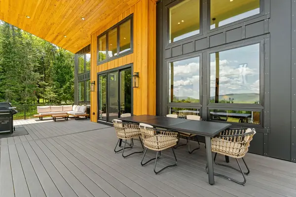 Covered porch with outdoor dining table and sweeping views