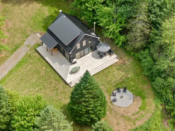 Aerial view of the cabin in its private clearing